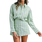 Green and white striped shirt worn by a person on a white background