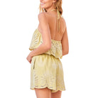 Pistachio lace romper on a white background