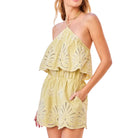 Pistachio lace romper worn by a model on a white background