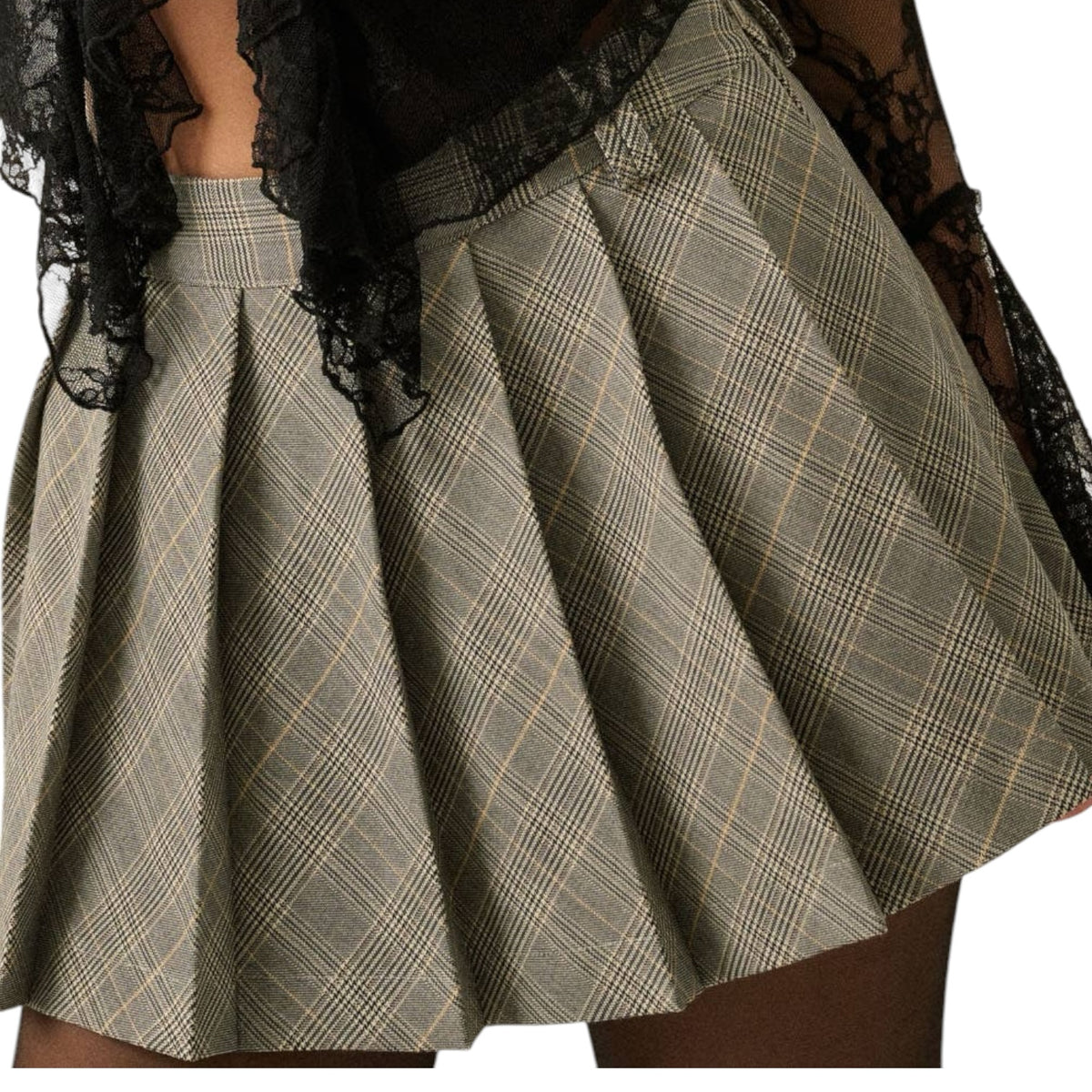 A pleated mini skirt in a muted sage green and beige plaid pattern, styled with a sheer black lace top against a plain white background.