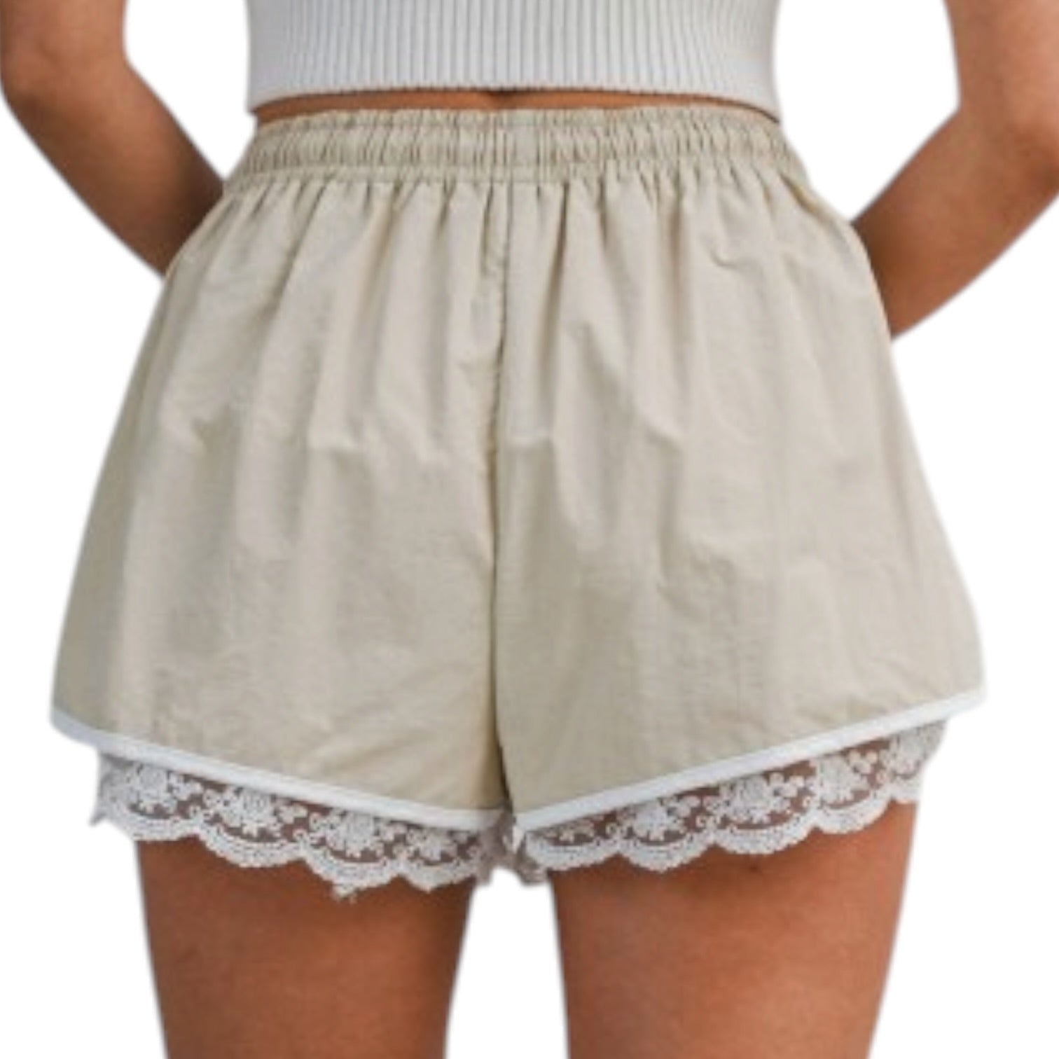 woman wearing beige shorts with white lace trim
