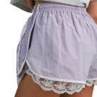 woman wearing lavender shorts with white lace trim