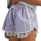 woman wearing lavender shorts with white lace trim