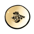 Round beige trinket dish with black rim and 'Please勿乱放' text, holding two rings.