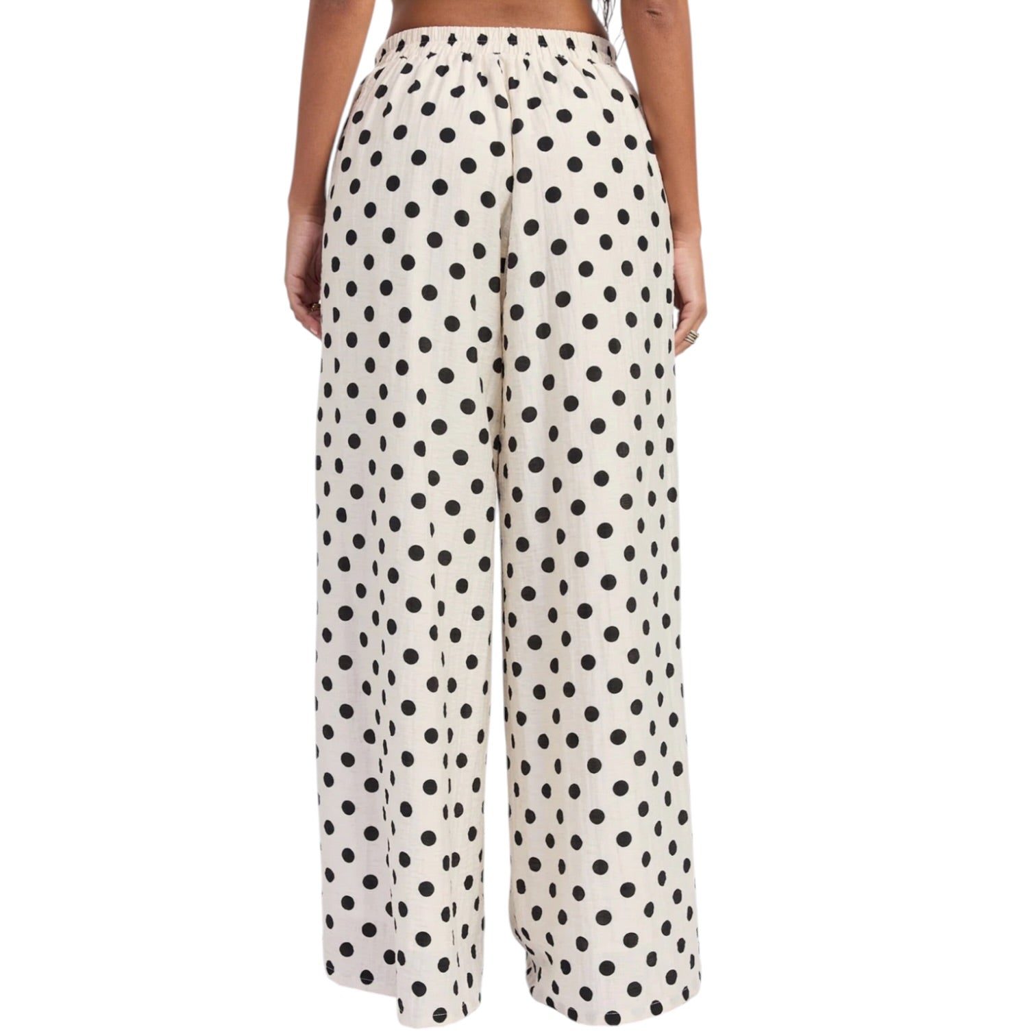 Polka dot pants worn by a person on a white background