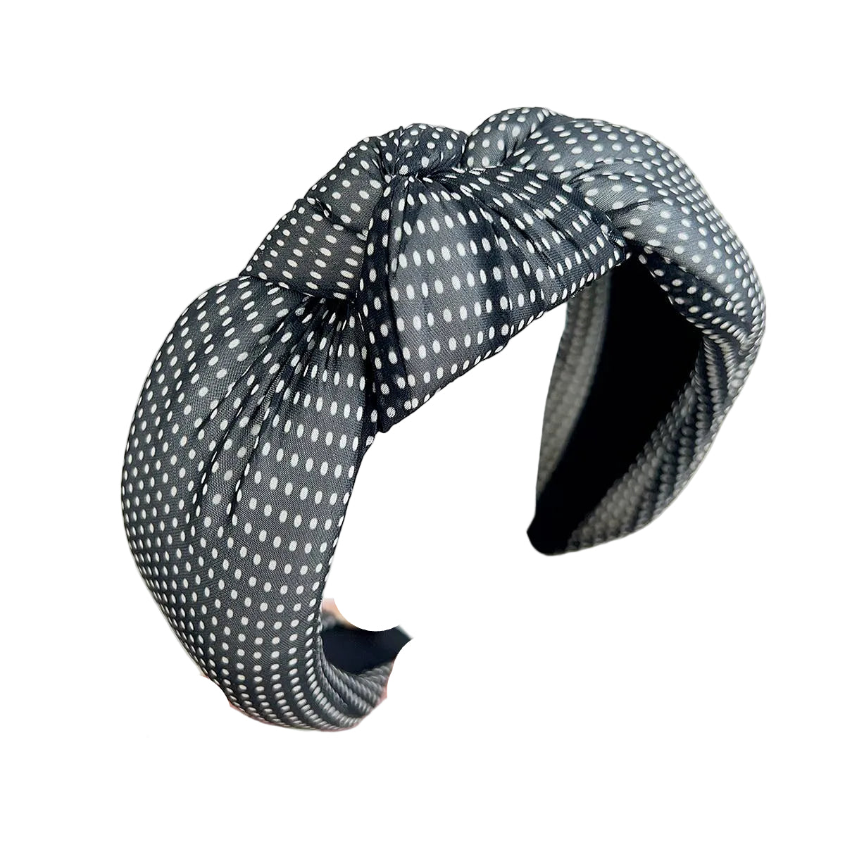 Polka dot headband held by a hand against a white background