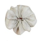 Hand holding a polka dot fabric flower against a white background