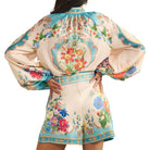 woman wearing a patterned short set on white background