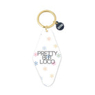 Keychain with 'Pretty But Loco' text and floral designs on a white background