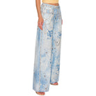 Light blue denim pants with embellishments on a white background