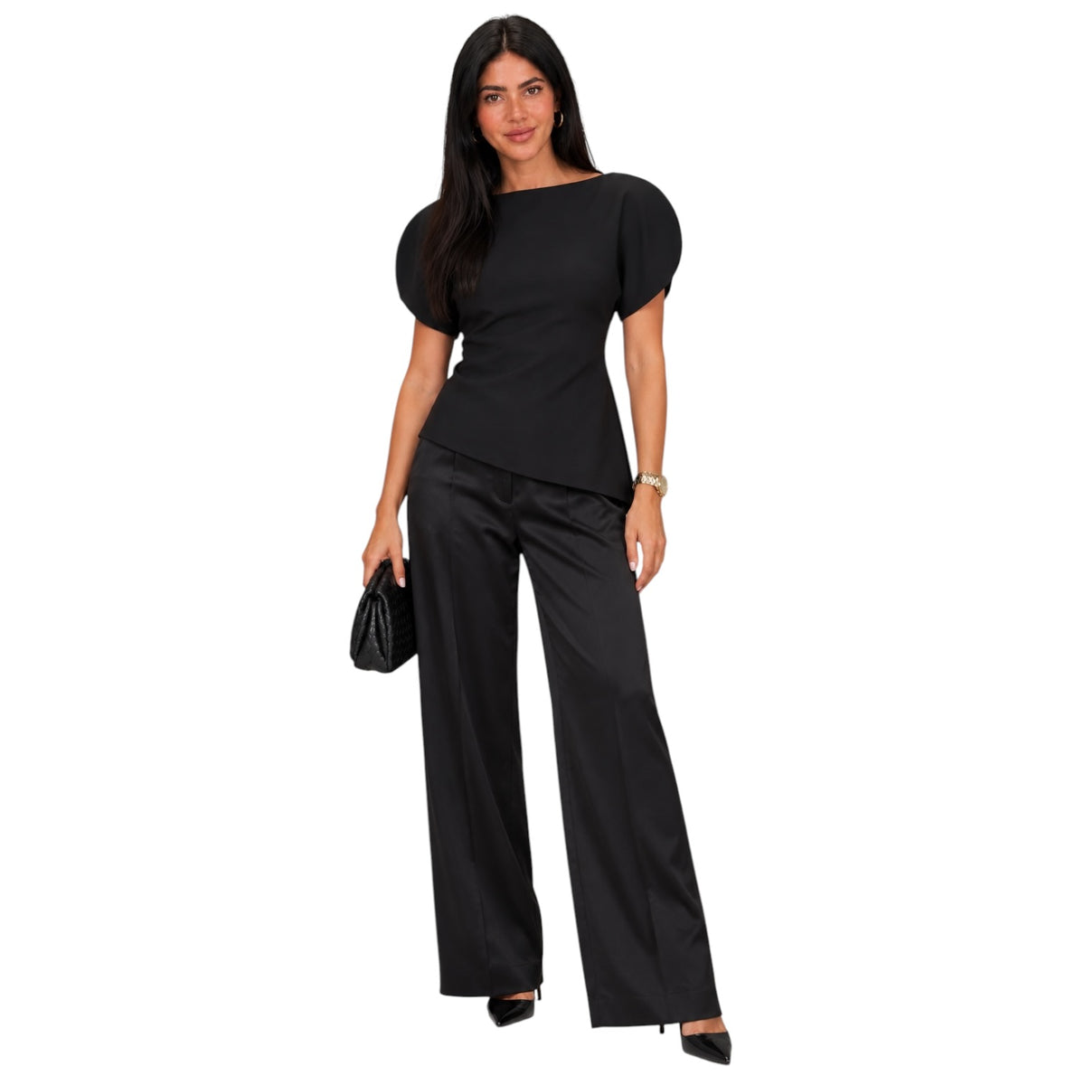 A woman modeling a black two-piece outfit consisting of a short-sleeve top with puffed sleeves and matching wide-leg trousers, shown against a plain white background.