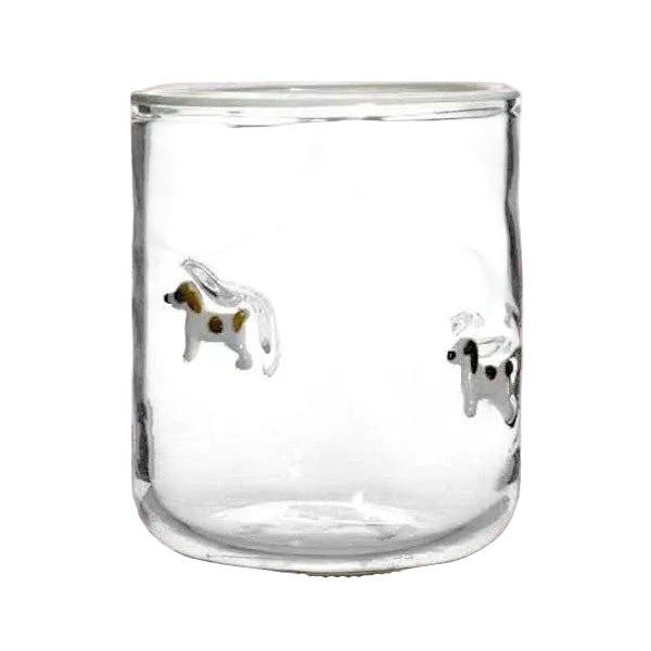 Clear glass tumbler with dog illustrations on a white background