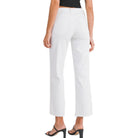 a woman wearing white jeans on a white background