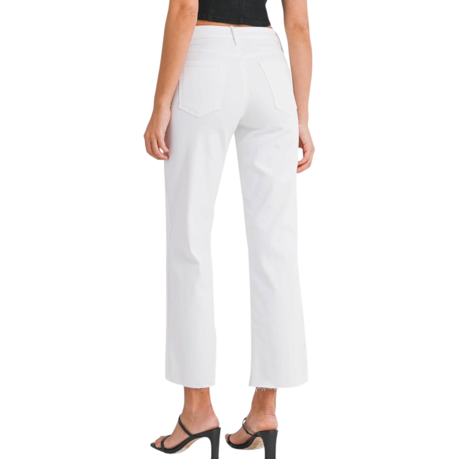 a woman wearing white jeans on a white background