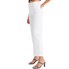 a woman wearing white jeans on a white background