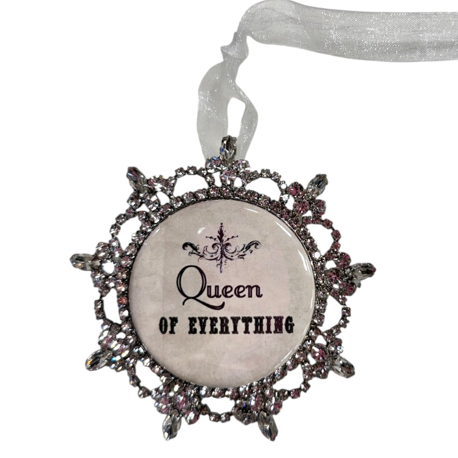 Decorative ornament with 'Queen of Everything' text and decorative frame on a white background