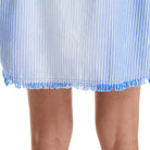 Close-up of a blue and white striped dress with frayed hem on a white background