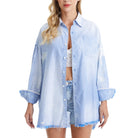 Woman wearing a blue and white striped shirt with rolled-up sleeves on a white background