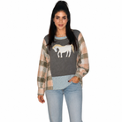 A woman modeling a long-sleeve knit sweater with a gray body, a white horse graphic, and peach-and-beige plaid sleeves, paired with light blue jeans against a plain white background.