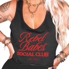 Black tank top with 'Rebel Babes Social Club' text worn by a person.