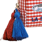 Red and white checkered bag with blue and red tassels on a white background