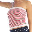 Red and white striped tube top worn by a person on a white background