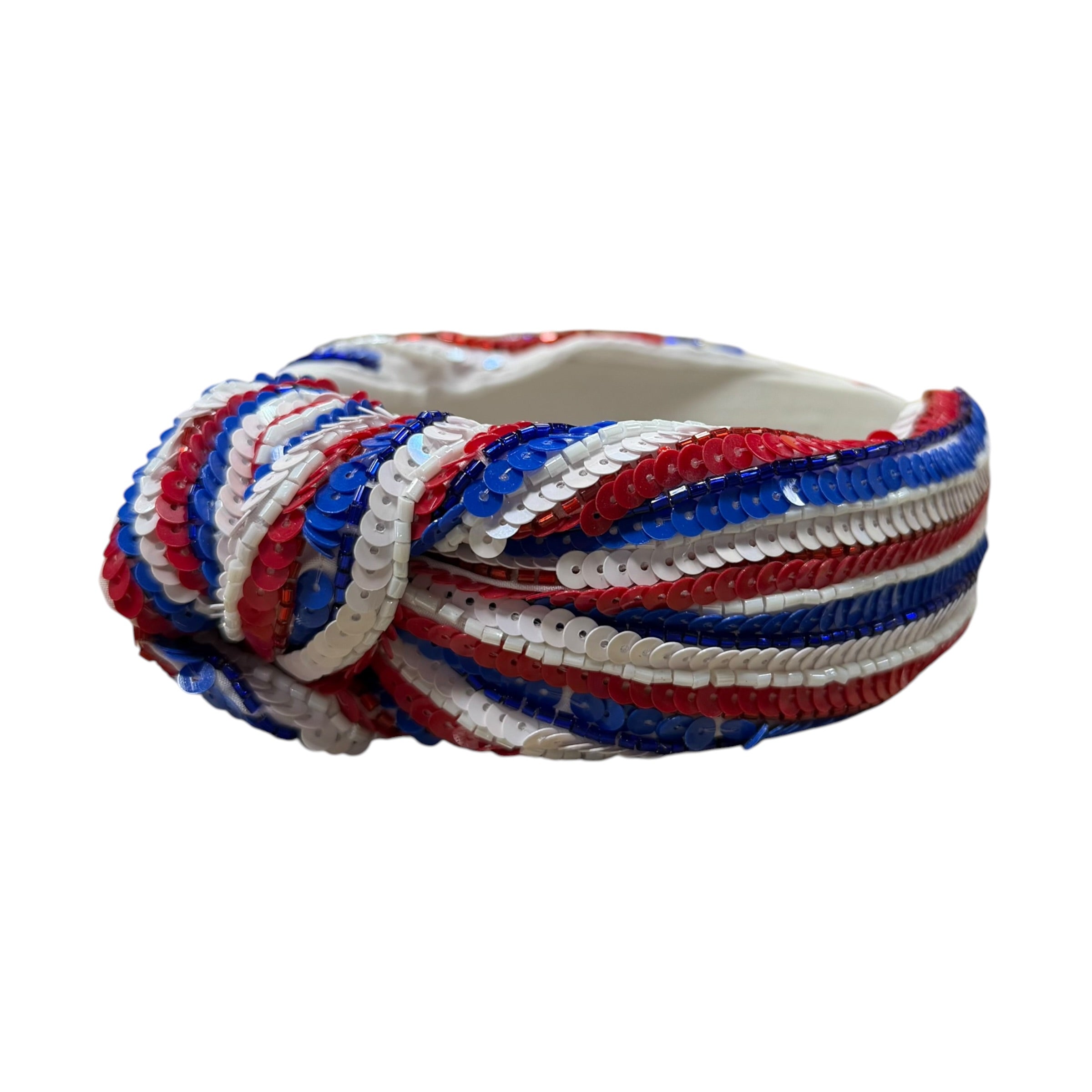 Decorative headband with red, white, and blue striped pattern on a white background