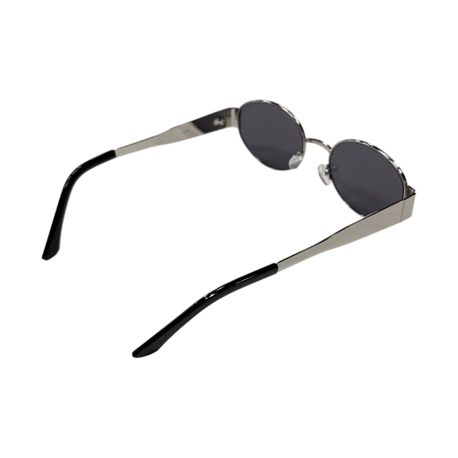 Small oval sunglasses with black lenses and silver frames on a white background