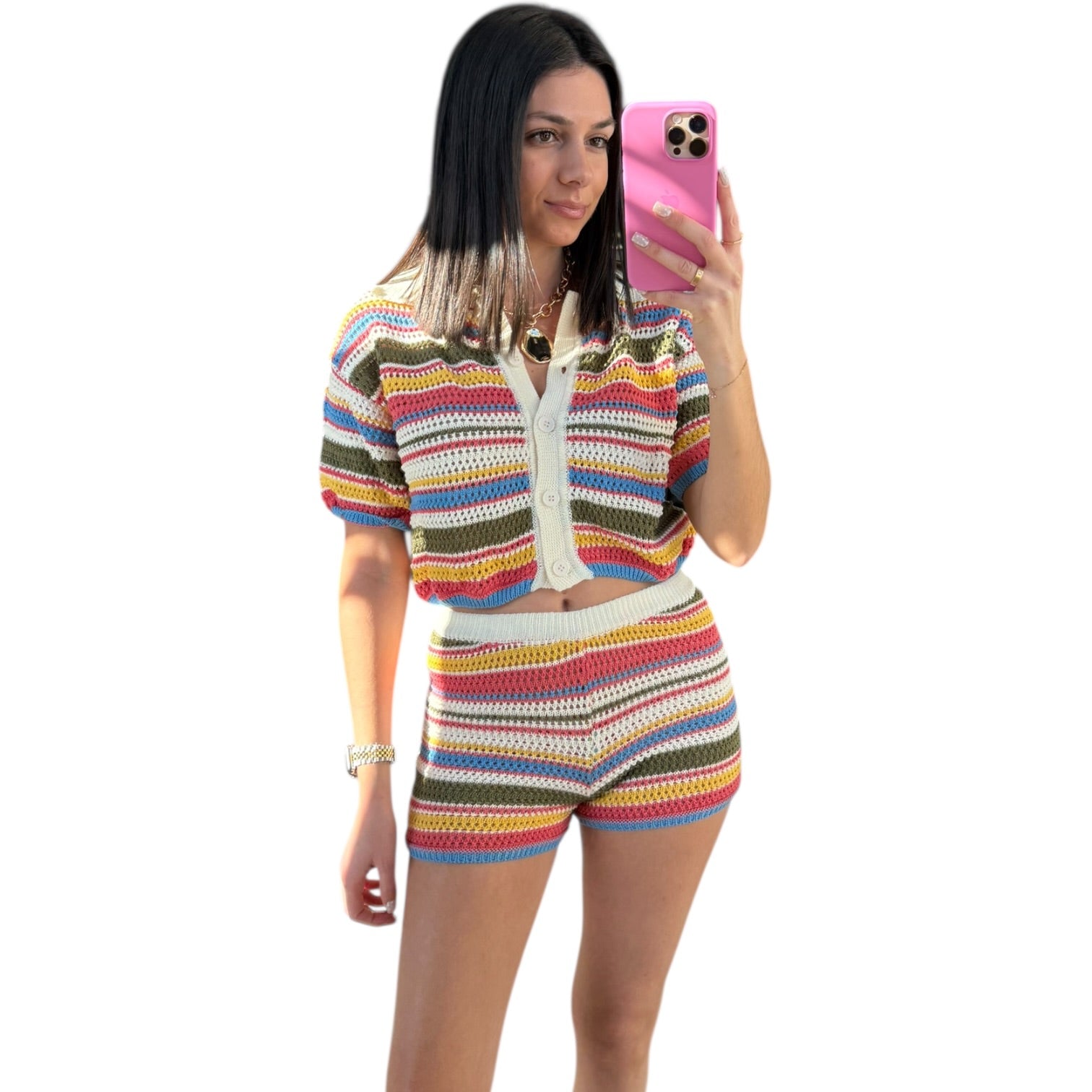 Woman taking a selfie wearing a colorful striped outfit on a white background