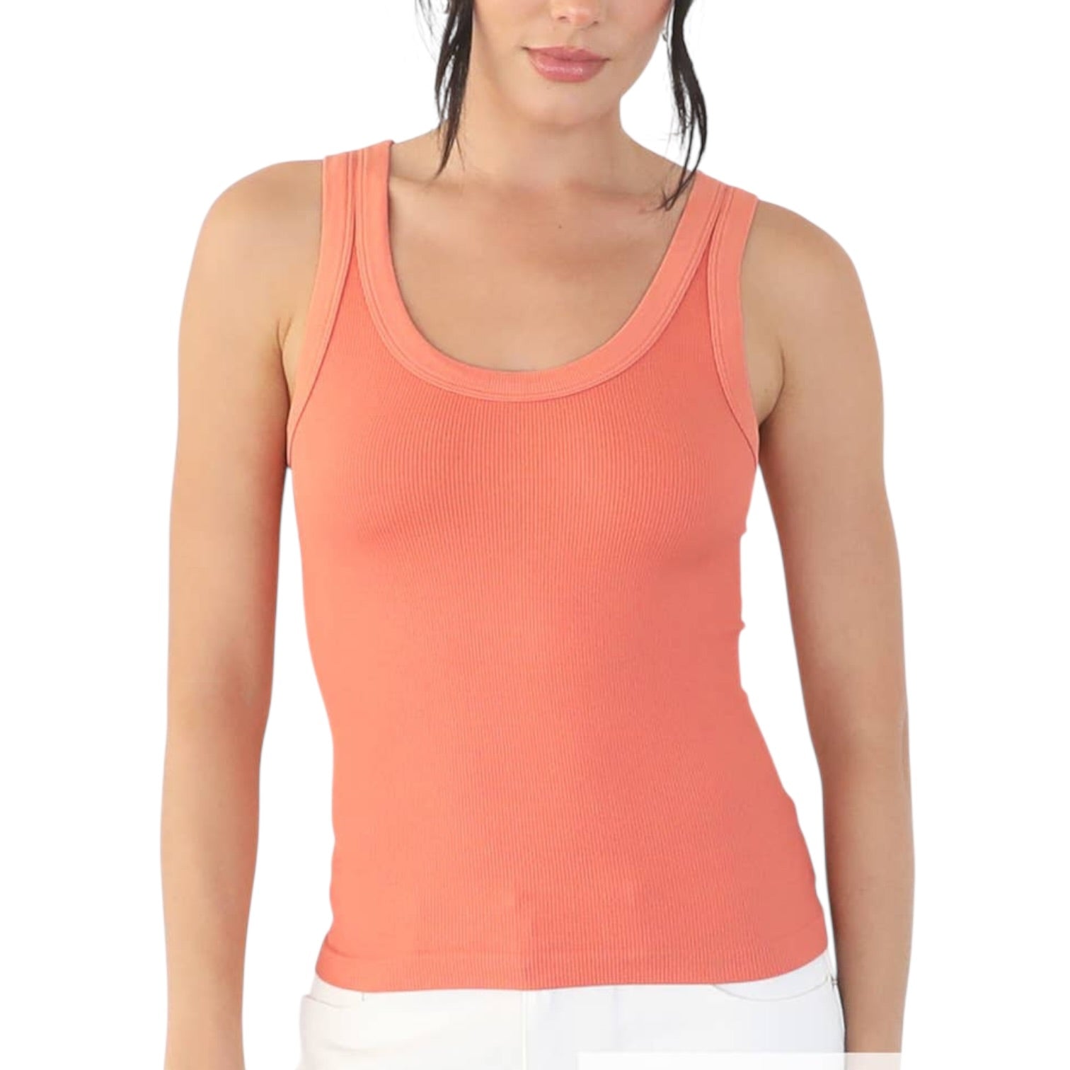 Woman wearing a coral tank top on a white background