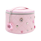 A light pink quilted cosmetic bag with a top handle, silver zipper, and decorative rhinestones and charms on a white background.