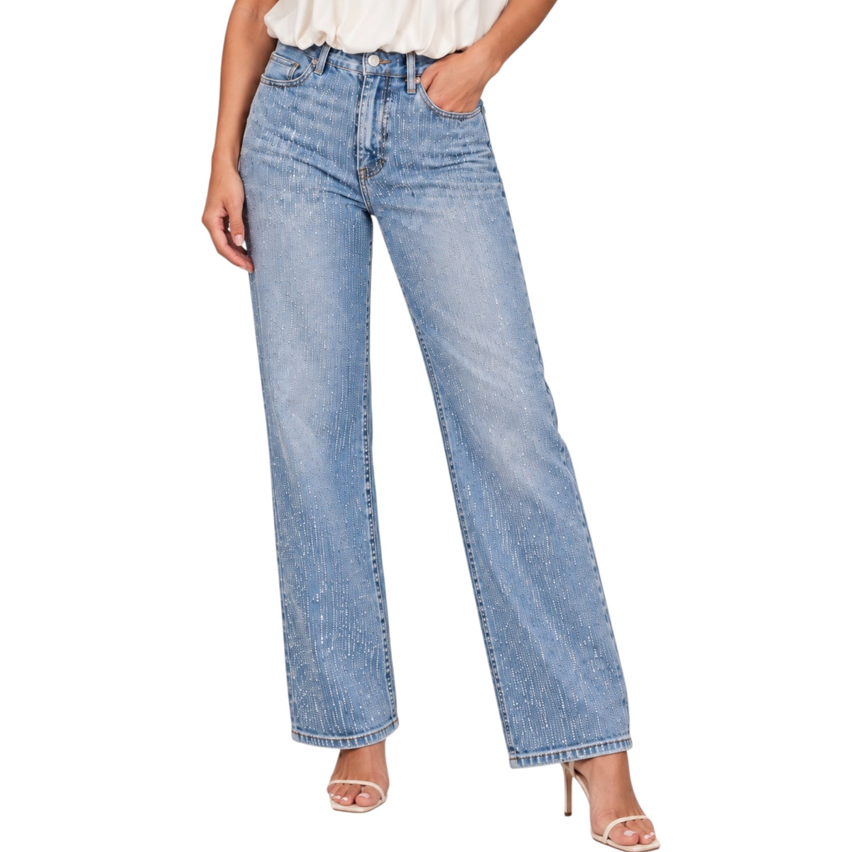 A model wearing a pair of light-wash blue wide-leg jeans with a faded texture, paired with a white top and clear high-heeled sandals, shown against a plain white background.