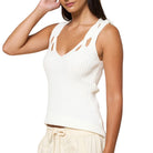 Woman wearing a white sleeveless top on a white background