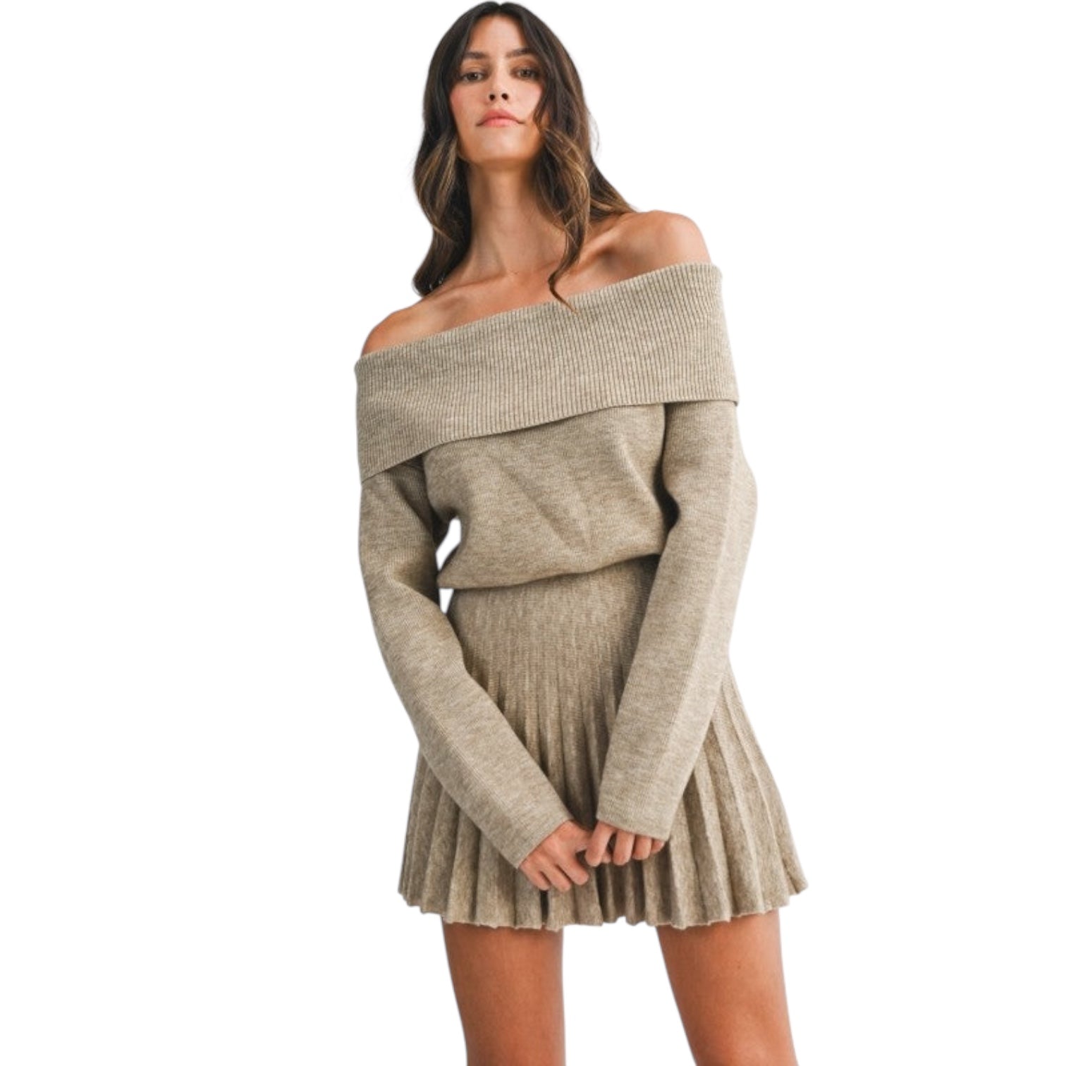 Woman wearing a beige off-shoulder sweater dress on a white background