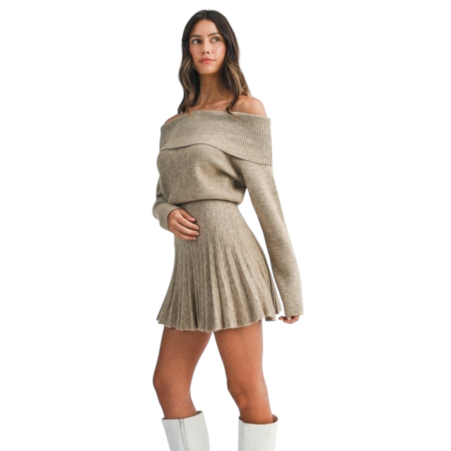 Woman wearing a beige off-shoulder sweater and pleated skirt set on a white background