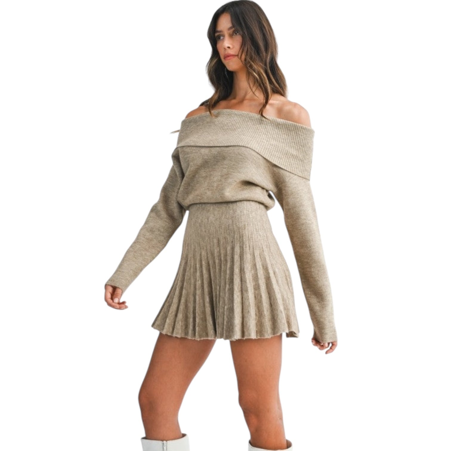 Woman wearing a beige off-shoulder sweater dress on a white background