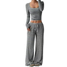 Black and white striped long-sleeve top and wide-leg pants on a white background