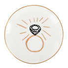 White plate with a black diamond design and gold accents on a white background