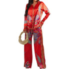 woman wearing red patterned set on white background
