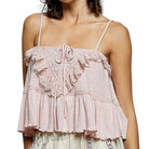 Pink lace top worn by a person on a white background