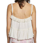 cream lace top with ruffled details on a white background