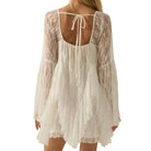 White lace romper with long sleeves on a white background