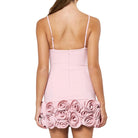 Pink dress with floral details on a white background
