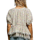 Floral blouse with ruffled layers on a white background