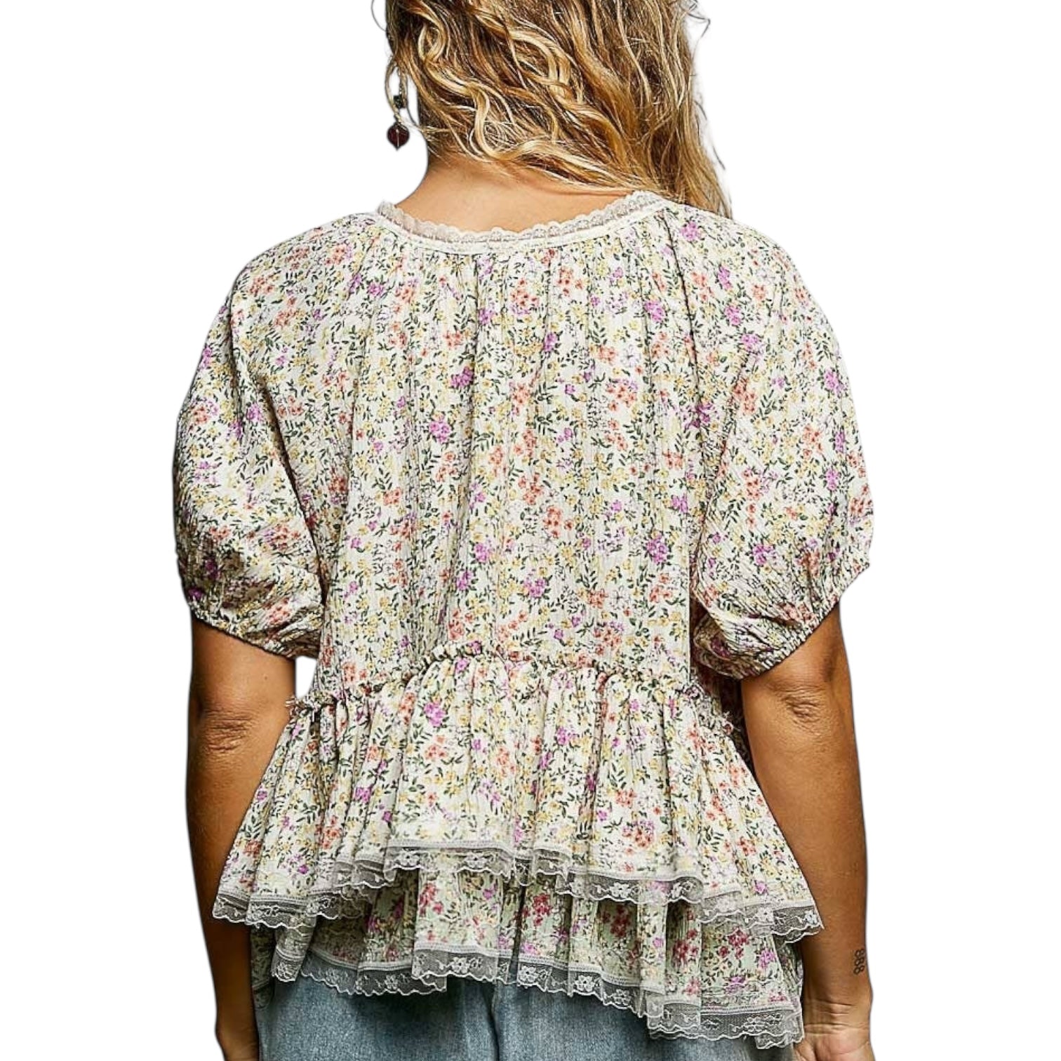 Floral blouse with ruffled layers on a white background