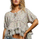 Woman wearing a floral blouse with a white background