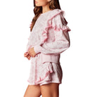 Pink floral set with ruffled sleeves on a white background