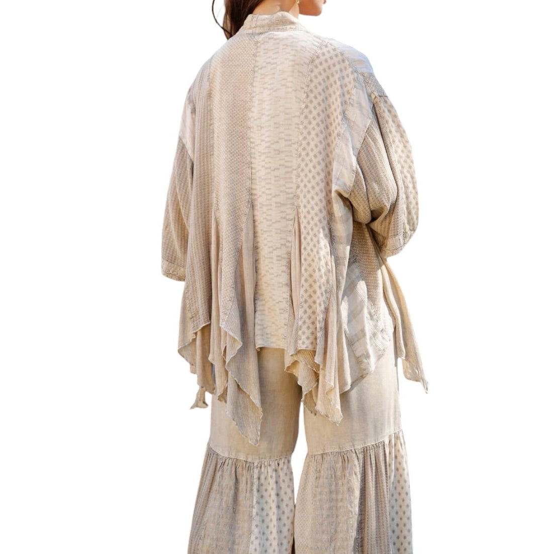 Beige layered outfit with a patterned top and wide-leg pants on a white background