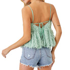 Light green feathered top worn by a person on a white background