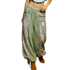 Green patchwork pants with floral patterns on a white background